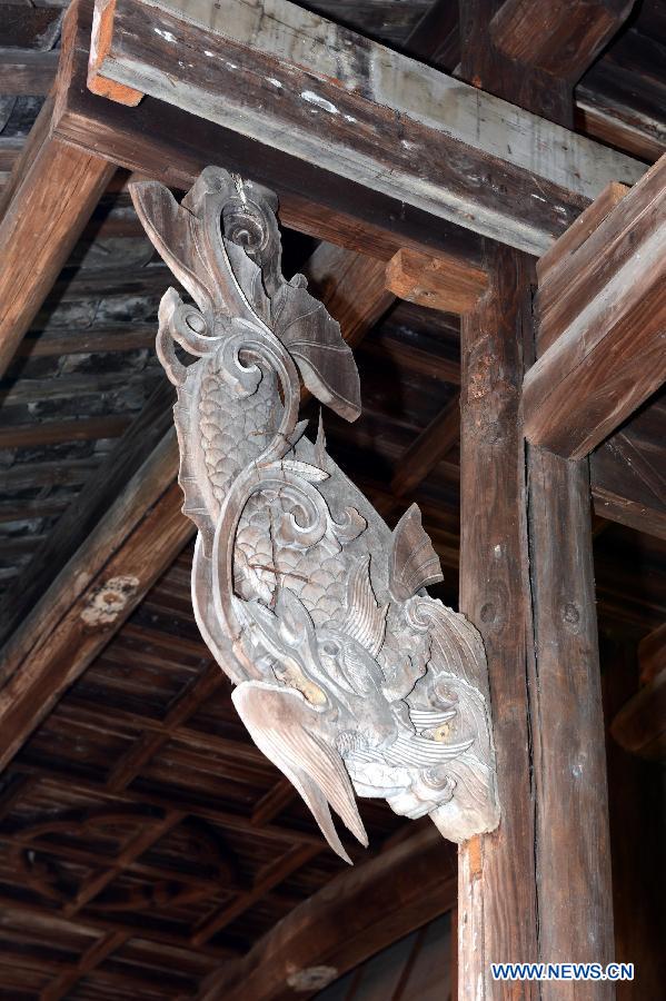 Photo taken on Jan. 30, 2013 shows a delicate wood carving on a door beam in Tianbao Village in Yifeng County, east China's Jiangxi Province. Tianbao Village, whose history is about 1,800 years, can date back to the Tang Dynasty (618-907), covering an area of more than 2.5 square kilometers. Tianbao was ever the county site of the ancient Yifeng County, carrying profound cultural connotation. There are more than 120 buildings in the village built in the Ming and Qing dynasties (1368-1912), all of which present high artistic value. The village has been listed in the pool of national cultural and natural heritage protection projects. (Xinhua/Song Zhenping)