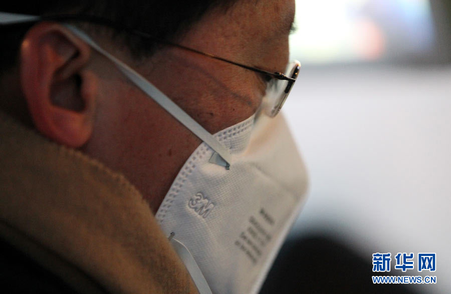 Beijing resident wears a breathing mask outside in the early morning of January 29th, 2013. (Photo/Xinhua)