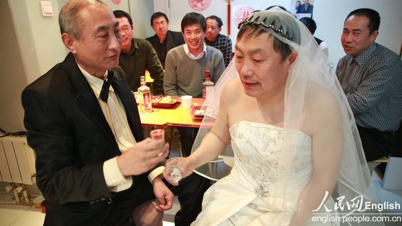 With the witness of several supporters, a special wedding ceremony for two old men is held in Pinggu district of Beijing, Jan. 30. Recently, a pair of old men, a retired teacher and a bottled water deliveryman, announced their engagement and became a hotly debated topic in China. (Photo/CFP)