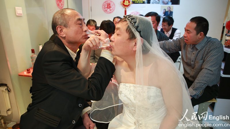 With the witness of several supporters, a special wedding ceremony for two old men is held in Pinggu district of Beijing, Jan. 30. Recently, a pair of old men, a retired teacher and a bottled water deliveryman, announced their engagement and became a hotly debated topic in China. (Photo/CFP)