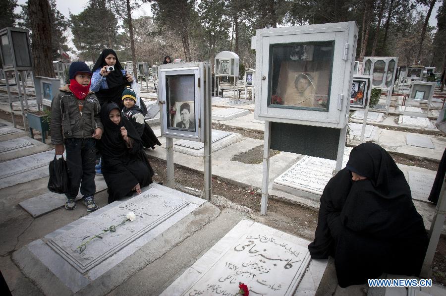 Iranians visit the graves of people who were killed during the 1979 Islamic revolution at the Behesht-e Zahra cemetery outside Tehran, Iran, on Jan. 31, 2013, to mark the 34th anniversary of the Islamic revolution. (Xinhua/Ahmad Halabisaz) 