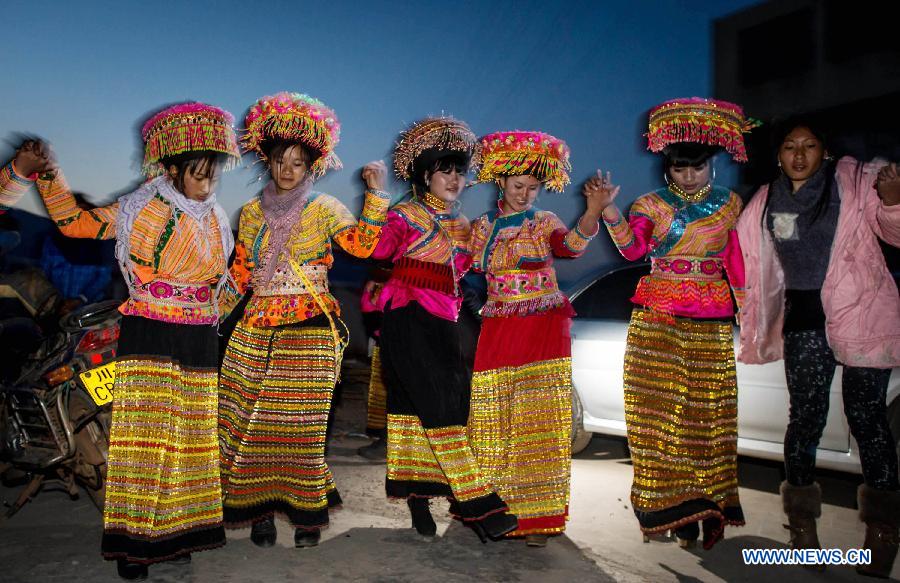 Women of Lisu ethnic group dance during a traditional wedding ceremony in Xinyu Village of Dechang County, southwest China's Sichuan Province, Jan. 31, 2013. Bride Gu Hongyan and bridegroom Lan Xiaoxiang held their wedding ceremony according to traditional custom of Lisu ethnic group. (Xinhua/Jiang Hongjing)