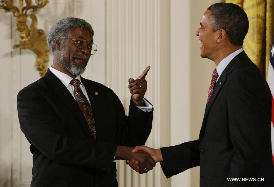 U.S. President Barack Obama laughs as he awards Dr. Sylvester James Gates from University of Maryland with the National Medal of Science during a ceremony at the White House in Washington D.C., the United States, on Feb. 1, 2013. (Xinhua/Fang Zhe)