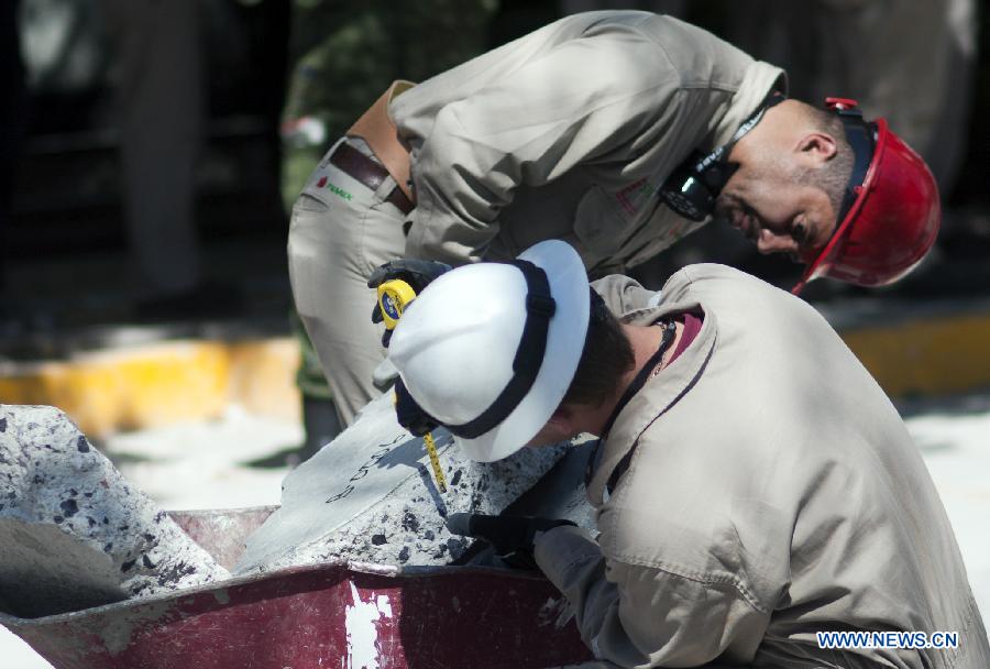 Experts work on the debris at the site of an explosion at the headquarters of Mexico's oil giant PEMEX, in Mexico City, capital of Mexico, on Feb. 2, 2013. Mexican and American experts carried out the research on reasons of the powerful explosion at the building E-B2 of the headquarters of Mexican oil giant Pemex, which caused the death of 33 people, injuring 121 others. (Xinhua/Shi Sisi)