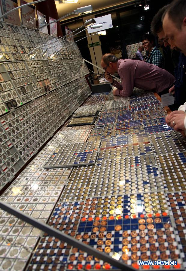 People visit the 42nd World Money Fair in Berlin, Germany, Feb. 2, 2013. More than 300 exhibitors, including mints and central banks, from more than 50 countries and regions attended the three-day fair, opened on Feb. 1. (Xinhua/Pan Xu)