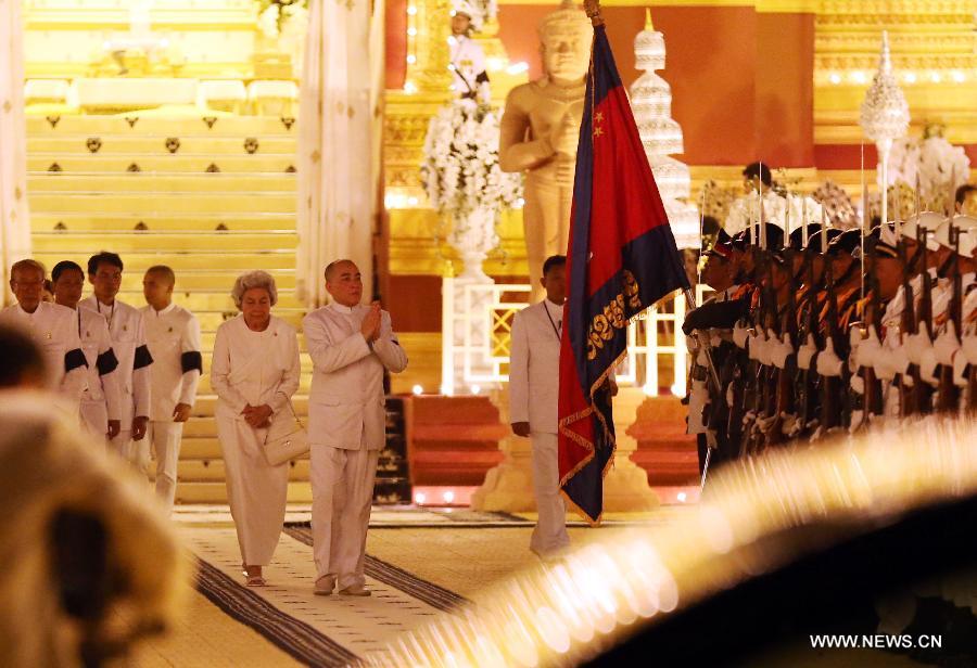 Sihanouk's wife Queen Mother Norodom Monineath (L-Central) and Cambodian King Norodom Sihamoni (R-Central) are seen at the custom-built funeral site where the body of the late Cambodian former King Norodom Sihanouk is placed, next to the Royal Palace in Phnom Penh, capital of Cambodia, on Feb. 3, 2013. The royal cremation ceremony of the late former Cambodian King Norodom Sihanouk will be held on Monday. (Xinhua/Yao Dawei)