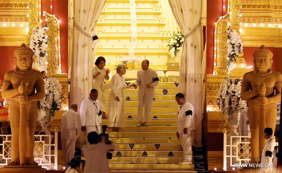 Sihanouk's wife Queen Mother Norodom Monineath (L-Central) and Cambodian King Norodom Sihamoni (R-Central) are seen at the custom-built funeral site where the body of the late Cambodian former King Norodom Sihanouk is placed, next to the Royal Palace in Phnom Penh, capital of Cambodia, on Feb. 3, 2013. The royal cremation ceremony of the late former Cambodian King Norodom Sihanouk will be held on Monday. (Xinhua/Yao Dawei)