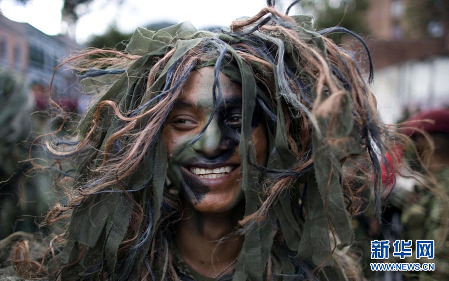 A solder wearing a camouflage wig participates in the military parade in Bogota, Colombia on July 20, 2011. (Photo/ Xinhua)