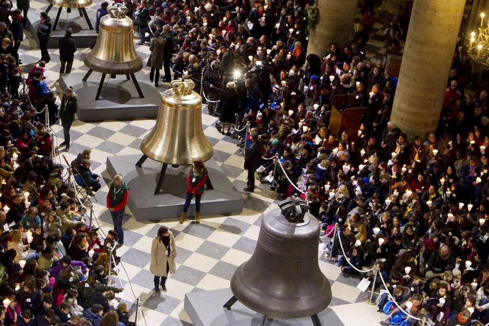 Some of the nine new bronze bells are displayed in Notre Dame Cathedral during a ceremony of blessing by Paris Archbishop Andre Vingt-Trois in Paris, Saturday, Feb. 1, 2013. Nine enormous new bronze bells have made their way at Notre Dame Cathedral, helping the medieval edifice to rediscover its historical harmony. (Xinhua News Agency/Reuters)