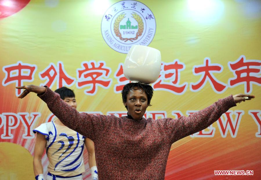 An overseas student performs acrobatics in an activity to celebrate the Chinese New Year at the Nanjing Agricultural University in Nanjing, capital of east China's Jiangsu Province, Feb. 4, 2013. More than 50 overseas students from over 20 countries and regions experienced Chinese traditional cultural activities with local students. (Xinhua)  