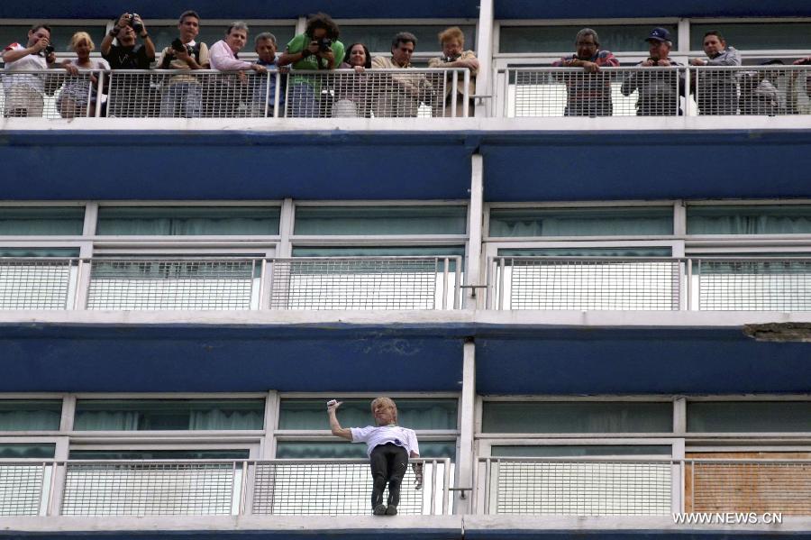 The so-called French Spiderman, Alain Robert, scales the landmark Havana Libre hotel without safety equipment in Havana, Cuba, on Feb. 4, 2013. (Xinhua/Joaquin Hernandez) 