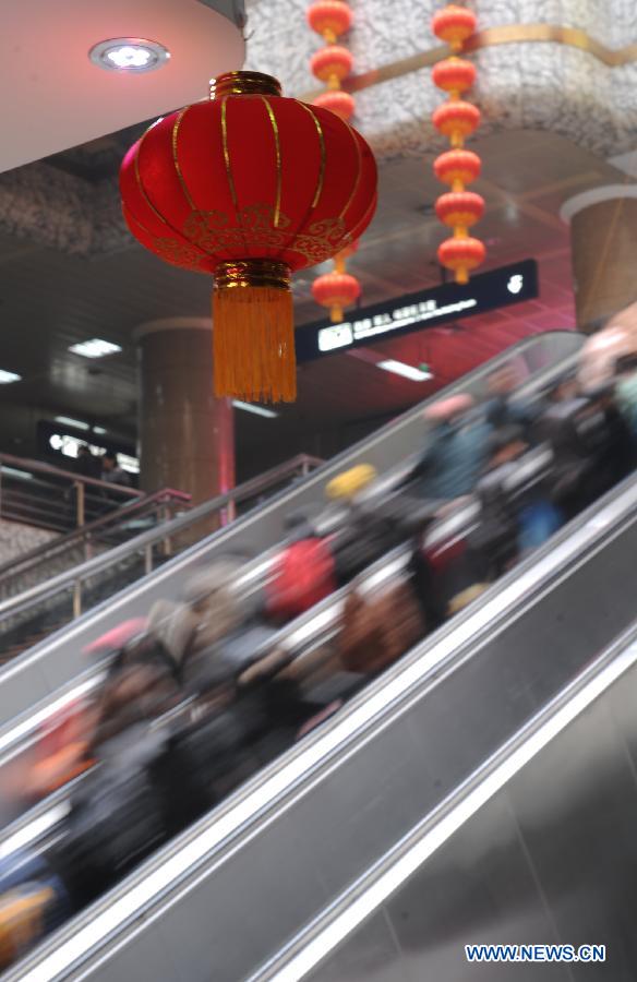 Passengers take elevator at the Zhengzhou Railway Station in Zhengzhou, capital of central China's Henan Province, Feb. 5, 2013. China's transport system sees an annual travel rush around the Spring Festival, which starts on Feb. 10 this year. (Xinhua/Li Bo)