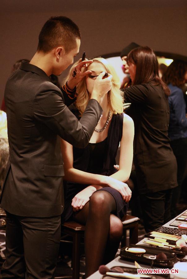 A model is prepared backstage prior to the WHIT Fall 2013 collection, at the W Hotel in Manhattan of New York, the United States, Feb. 6, 2013. The WHIT Fall 2013 collection, inspired by romantic movements and themes, emphasizes a young dreamy Marianne Faithful. Following a bright Spring Collection, the Fall Collection settles on a darker palate with fresh plays on plaids, paisleys, and animal print. (Xinhua/Zhai Xi)