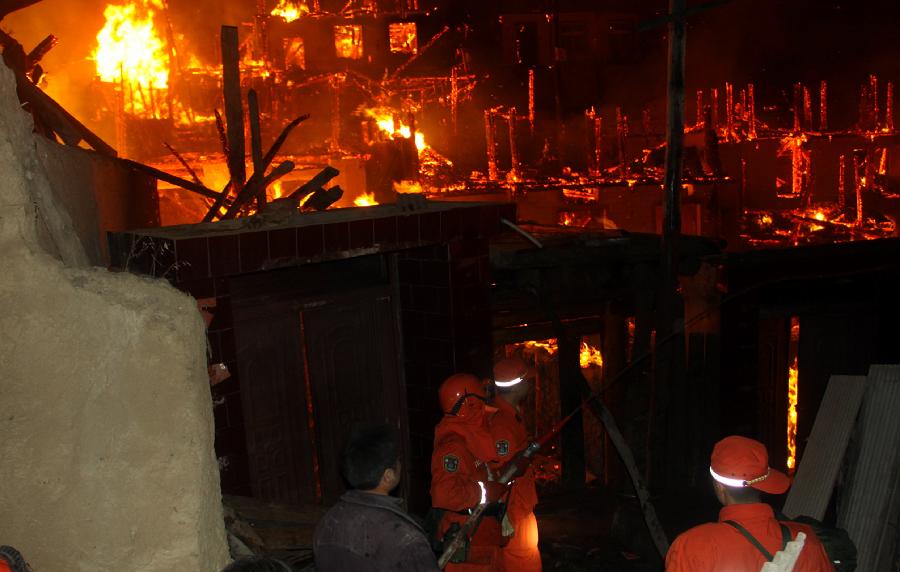 Soldiers fight fires at the scene of a fire in Heiduo Village of Diebu County in northwest China's Gansu Province, Feb. 7, 2013. The fire broke out in Heiduo Village around 8 p.m. and was put out Thursday morning, leaving destruction of 92 homes and no casualties. (Xinhua/Liu Wenchao)