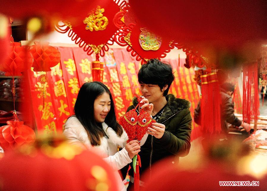 A couple select ornaments for the coming Spring Festival in Sizhou Town of Dexing City, east China's Jiangxi Province, Feb. 8, 2013. The Spring Festival, the most important occasion for the family reunion for the Chinese people, falls on the first day of the first month of the traditional Chinese lunar calendar, or Feb. 10 this year. (Xinhua/Zhuo Zhongwei)