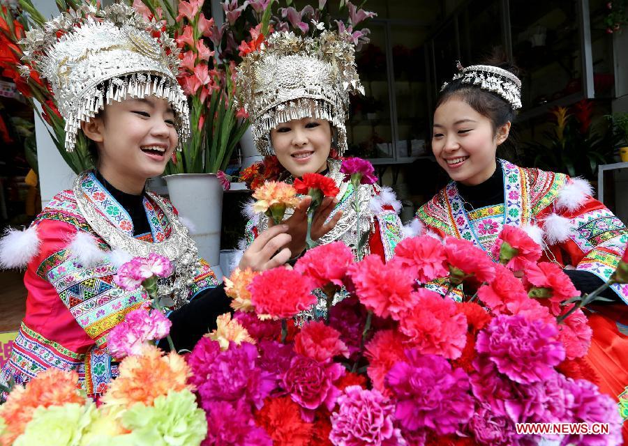 Young ladies of the Miao ethnic group select flowers for the coming Spring Festival in Rongshui County, south China's Guangxi Zhuang Autonomous Region, Feb. 8, 2013. The Spring Festival, the most important occasion for the family reunion for the Chinese people, falls on the first day of the first month of the traditional Chinese lunar calendar, or Feb. 10 this year. (Xinhua/Long Tao)