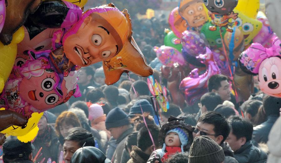 Cartoon balloons are sold in a business street in Tianjin, north China, Feb. 12, 2013. People in China are enjoying the week-long holiday of Spring Festival, or Chinese Lunar New Year. Numerous travelers has crammed in tourism sites across the country. (Xinhua/Zhao Huixiang) 