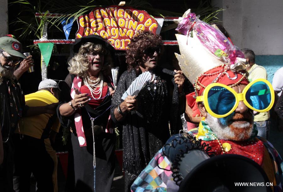 People attend the popular party called "El Entierro de la Sardina", in Naiguata, in the state of Vargas, Venezuala, on Feb. 14, 2013. The popular party "El Entierro de la Sardina" marks the end of the Carnival celebrations. (Xinhua/Juan Carlos La Cruz/AVN)