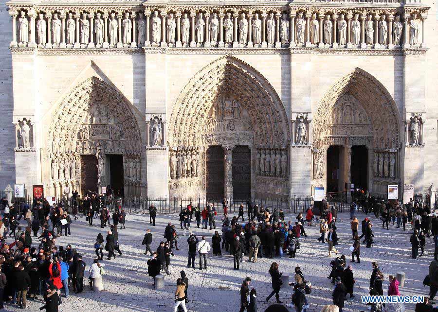 People visit the Notre Dame de Paris cathedral in Paris, France, Feb. 15, 2013. Notre Dame in Paris will celebrate its 850th anniversary on March 23. Nine new bells will be installed on the cathedral's twin towers to recreate the harmonious chimes before the French Revolution. The new bells are now on display for the public at Notre Dame before ringing on the cathedrale's 850th birthday. (Xinhua/Gao Jing)