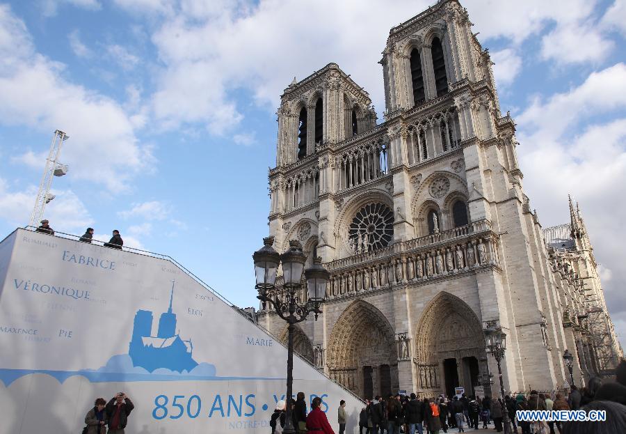 People visit the Notre Dame de Paris cathedral in Paris, France, Feb. 15, 2013. Notre Dame in Paris will celebrate its 850th anniversary on March 23. Nine new bells will be installed on the cathedral's twin towers to recreate the harmonious chimes before the French Revolution. The new bells are now on display for the public at Notre Dame before ringing on the cathedrale's 850th birthday. (Xinhua/Gao Jing)