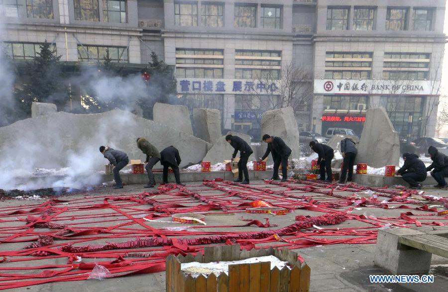 Staff members of an enterprise set off firecrackers at Fengtian Yinzuo Square in Shenyang, capital of northeast China's Liaoning Province, Feb. 16, 2013. Saturday marks the first working day after the one-week Spring Festival break which started on Feb. 9. Setting off firecrackers on this day is a traditional custom for businessmen to pray for a booming year. (Xinhua/Zhao Jingdong)