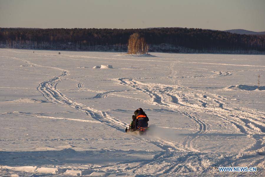 A member of Russian ministry of emergency situations (C) rides a snow motorbike to the site of the meteorite fall at the chebarkul lake near Chelyabinsk, about 1500 kilometers east of Moscow, Russia, Feb. 16, 2013. A meteorite burst into the sky over Russia's Urals region on Friday. Emergency Situations Minister Vladimir Puchkov said there was no proof that meteoritic fragments have been found. (Xinhua/Jiang Kehong) 