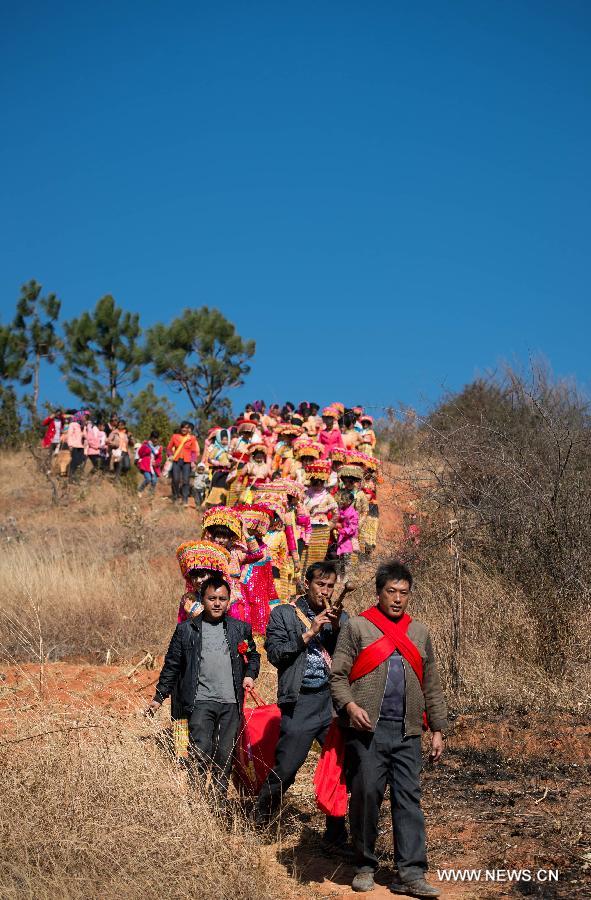 A Lisu wedding procession made up of members from the bride's side heads for the groom's home in Xinyu Village of Dechang County, southwest China's Sichuan Province, Feb. 15, 2013. Dechang's Lisu people live in family- or clan-based villages most of which locates on river valley slopes of around 1,500 to 3,000 meters above the sea level. They still practice a wedding tradition that has uncommon conventions including bridal face-shaving, outdoor wedding banquet and overnight group dance. (Xinhua/Jiang Hongjing) 