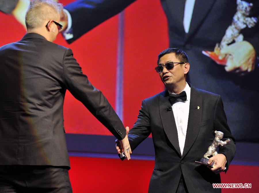 Jury President and Chinese Director Wong Kar Wai (R) attends the awards ceremony at the 63rd Berlinale International Film Festival in Berlin, Feb. 16, 2013. (Xinhua/Ma Ning)