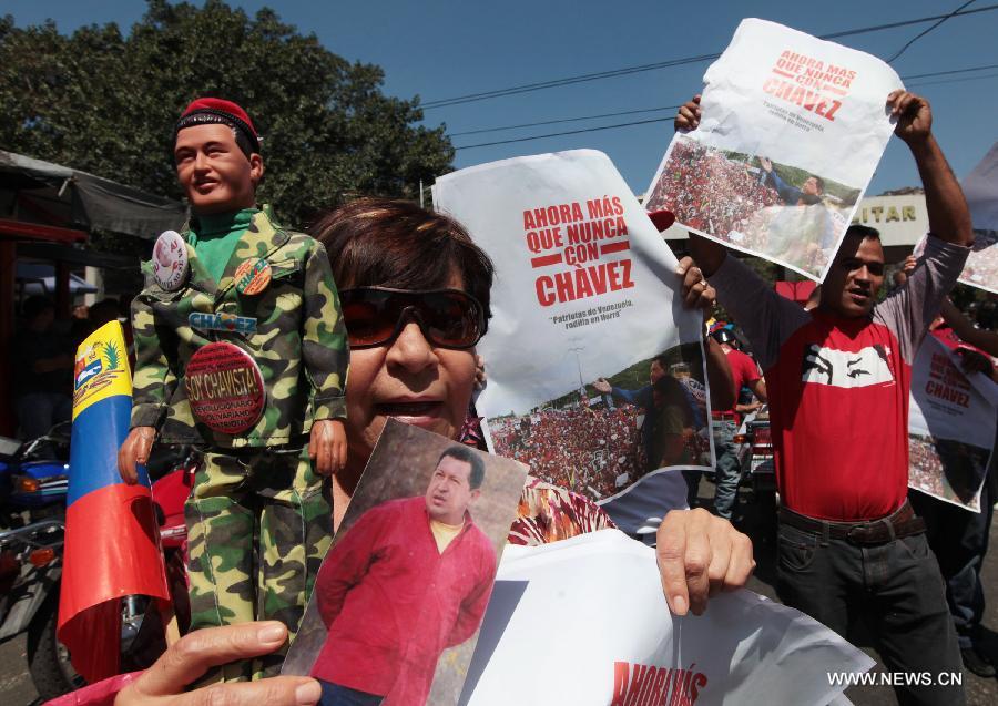 Image provided by the Venezuelan Presidency shows the supporters of Venezuela's President Hugo Chavez celebrating his return at Bolivar Square, in Caracas, Venezuela, on Feb. 18, 2013. Chavez was back in Venezuela early Monday after more than two months in Cuba recovering from cancer surgery. He was immediately admitted to Caracas' military hospital in Caracas to continue anti-cancer treatment. (Xinhua) 