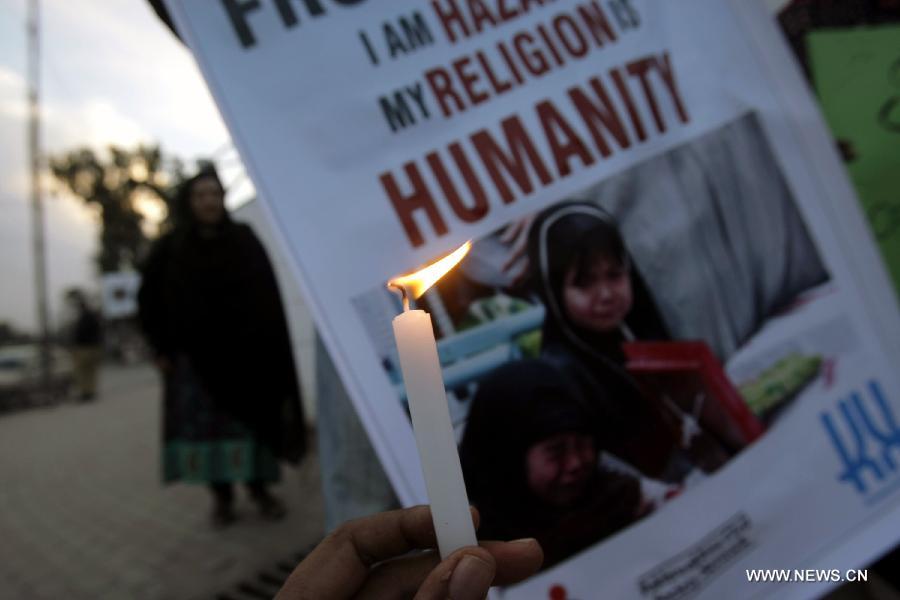 A Pakistani civil activist holds a candle during a candlelight vigil for the victims of the deadly blast in Quetta killing 87 people last Saturday, in northwest Pakistan's Peshawar, Feb. 19, 2013. (Xinhua Photo/Umar Qayyum)