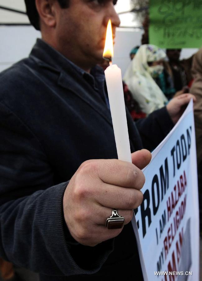 A Pakistani civil activist holds a candle during a candlelight vigil for the victims of the deadly blast in Quetta killing 87 people last Saturday, in northwest Pakistan's Peshawar, Feb. 19, 2013. (Xinhua Photo/Umar Qayyum)