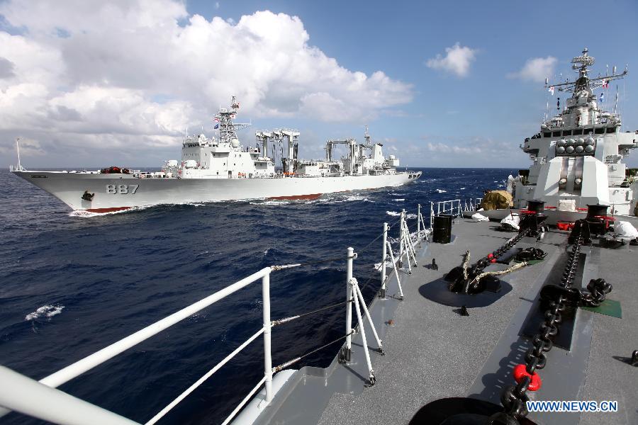 Missile destroyer Harbin (R) sail close to the supply ship Weishanhu at South China Sea, Feb. 20, 2013. The supply ship Weishanhu reinforced the missile destroyer Harbin and the frigate Mianyang on Wednesday with fuel, fresh water and other materials. The 14th naval squad, sent by the Chinese People's Liberation Army (PLA) Navy, departed Saturday from China to the Gulf of Aden and Somali waters for escort missions. The fleet comprises three ships -- the missile destroyer Harbin, the frigate Mianyang and the supply ship Weishanhu -- carrying two helicopters and a 730-strong troop. (Xinhua/Rao Rao)