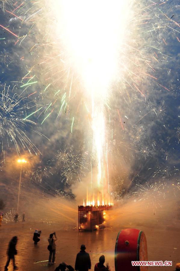 People play firework during a firecracker dragon festival in Binyang County of south China's Guangxi Zhuang Autonomous Region, Feb. 20, 2013. The Binyang-style dragon dance is a derivative of traditional dragon dance in which performers hold dragon on poles and walk through floods of firecrackers. The dance, dating back to over 1,000 years ago, was listed as a state intangible cultural heritage in 2008. (Xinhua/Huang Xiaobang) 