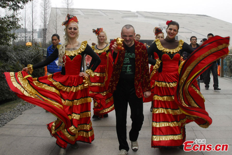 People in colorful costumes participate in a parade held to celebrate the Jinsha Sun Festival in Jinsha Village, Chengdu, Southwest China's Sichuan Province, February 20, 2013. Jinsha Village is home to the Jinsha Relics Museum, which, located at the Jinsha Archeological Site, is a theme park-style museum for the protection of, research into and display of Jinsha relics and archaeological finds. (CNS/Jin Sha)