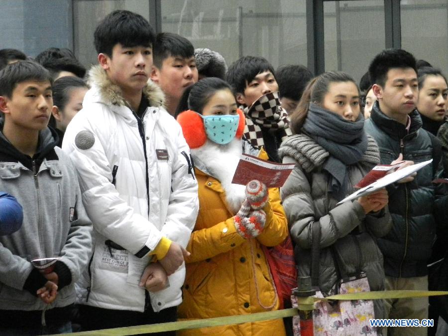 Examinees wait to sign up for the entrance examination of the Beijing Film Academy (BFA) in Beijing, capital of China, Feb. 21, 2013. BFA is one of China's leading bases of movie education, where many movie celebrities like director Zhang Yimou and numerous actors graduated. With the dreams to become future movie stars, thousands of young people cram to BFA for the enrollment exam every year. (Xinhua/Wang Zhen)