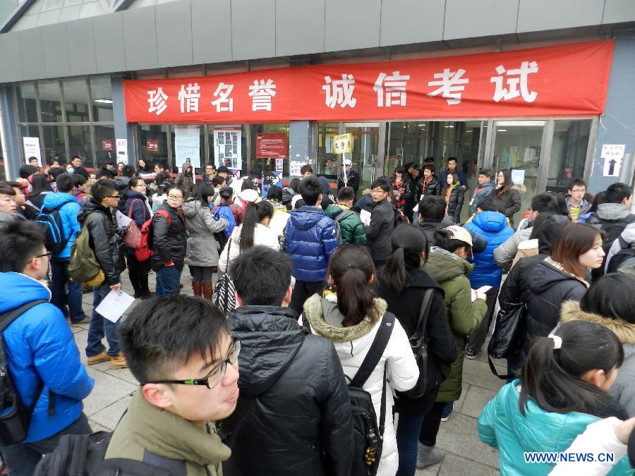 Examinees wait to sign up for the entrance examination of the Beijing Film Academy (BFA) in Beijing, capital of China, Feb. 21, 2013. BFA is one of China's leading bases of movie education, where many movie celebrities like director Zhang Yimou and numerous actors graduated. With the dreams to become future movie stars, thousands of young people cram to BFA for the enrollment exam every year. (Xinhua/Wang Zhen)