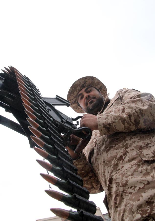 A Libyan soldier demonstrates his skills during a military parade for the second anniversary of a political upheaval that toppled former leader Muammar Gaddafi in the Libyan capital Tripoli, on Feb. 21, 2013 (Xinhua/Hamza Turkia) 