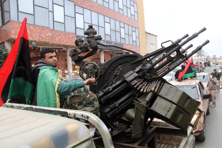 Libyan soldiers demonstrate their skills during a military parade for the second anniversary of a political upheaval that toppled former leader Muammar Gaddafi in the Libyan capital Tripoli, on Feb. 21, 2013 (Xinhua/Hamza Turkia) 