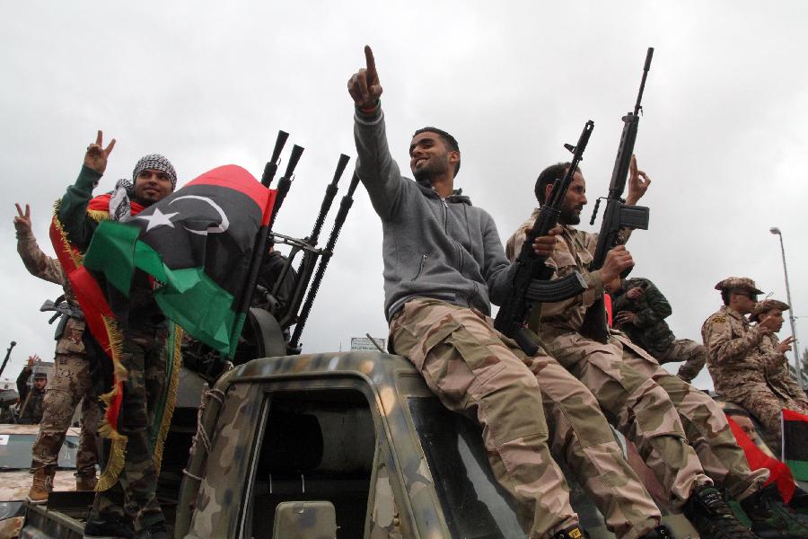 Libyan soldiers demonstrate their skills during a military parade for the second anniversary of a political upheaval that toppled former leader Muammar Gaddafi in the Libyan capital Tripoli, on Feb. 21, 2013 (Xinhua/Hamza Turkia) 