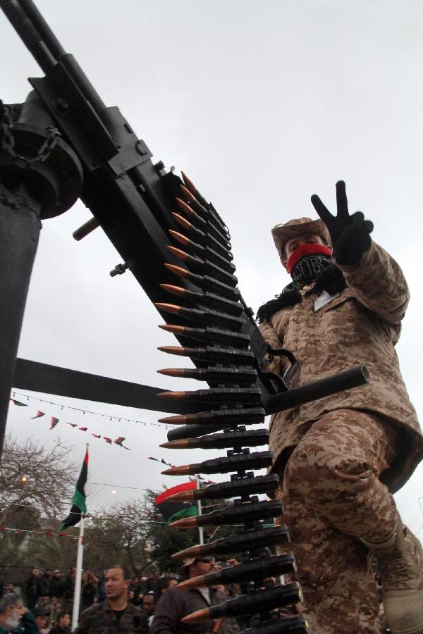 A Libyan soldier demonstrates his skills during a military parade for the second anniversary of a political upheaval that toppled former leader Muammar Gaddafi in the Libyan capital Tripoli, on Feb. 21, 2013 (Xinhua/Hamza Turkia) 