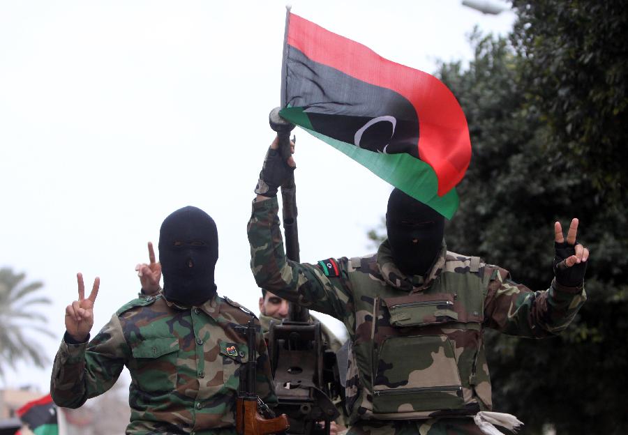 Libyan soldiers demonstrate their skills during a military parade for the second anniversary of a political upheaval that toppled former leader Muammar Gaddafi in the Libyan capital Tripoli, on Feb. 21, 2013 (Xinhua/Hamza Turkia) 