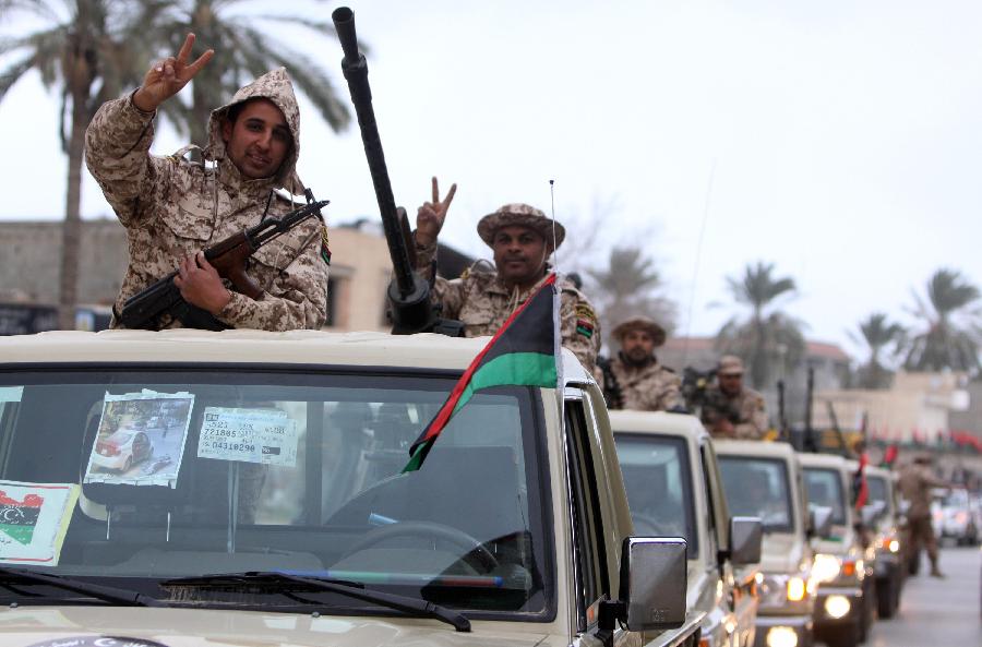 Libyan soldiers demonstrate their skills during a military parade for the second anniversary of a political upheaval that toppled former leader Muammar Gaddafi in the Libyan capital Tripoli, on Feb. 21, 2013 (Xinhua/Hamza Turkia) 