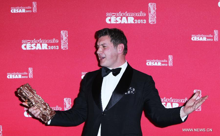 French screenwriter Thomas Bidegain poses with his Best Adapted Screenplay award for the movie 'De Rouille et d'Os' during the 38th annual Cesar awards ceremony held at the Chatelet Theatre in Paris, Feb. 22, 2013. (Xinhua/Gao Jing)