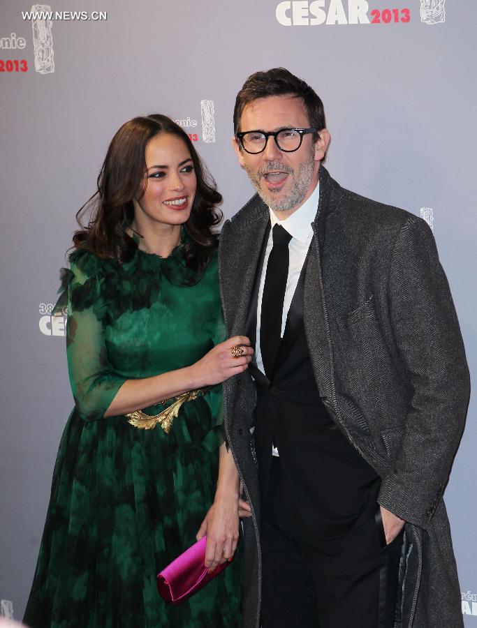 French actress Berenice Bejo (L) and French director Michel Hazanavicius (R) arrive at the 38th annual Cesar awards ceremony held at the Chatelet Theatre in Paris, France, Feb. 22, 2013. (Xinhua/Gao Jing) 