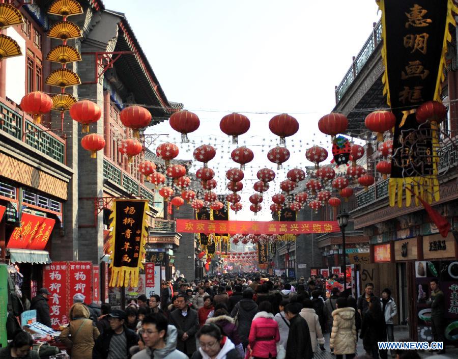 Visitors enjoy themselves at an ancient street in north China's Tianjin Municipality, Feb. 23, 2013. As the Lantern Festival falls on the next day, various lanterns were set up at the ancient street, which offers a place for local citizens in Tianjin to experience the culture of the festival. (Xinhua/Zhang Chenlin)