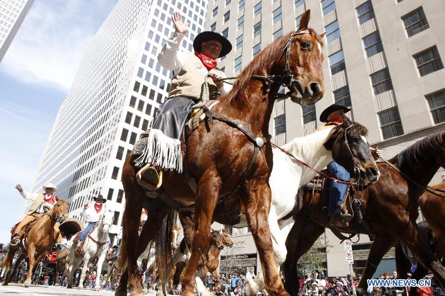 People dressed up as cowboys attend the annual Houston Rodeo parade in Houston, the United States, Feb. 23, 2013. (Xinhua/Song Qiong) 