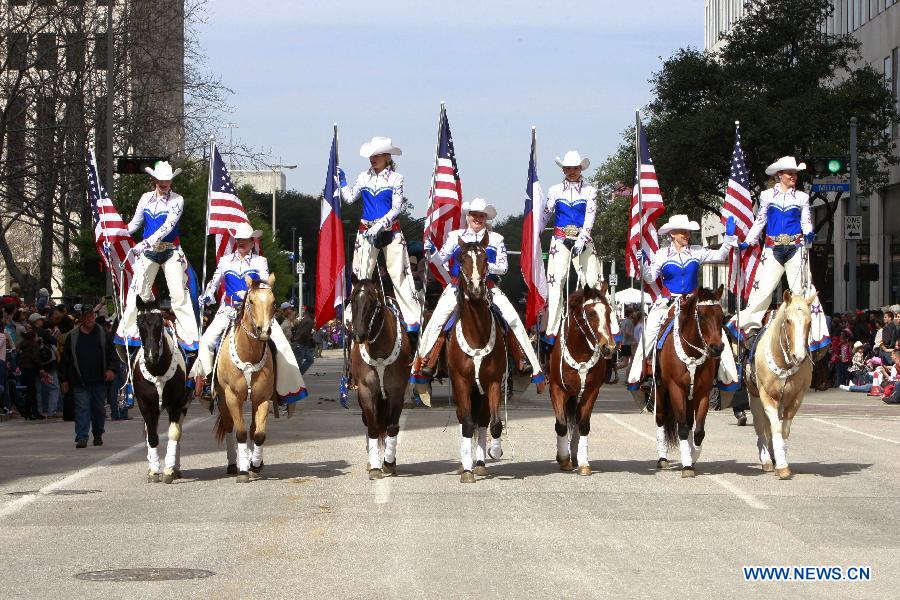 People dressed up as cowboys attend the annual Houston Rodeo parade in Houston, the United States, Feb. 23, 2013. (Xinhua/Song Qiong) 