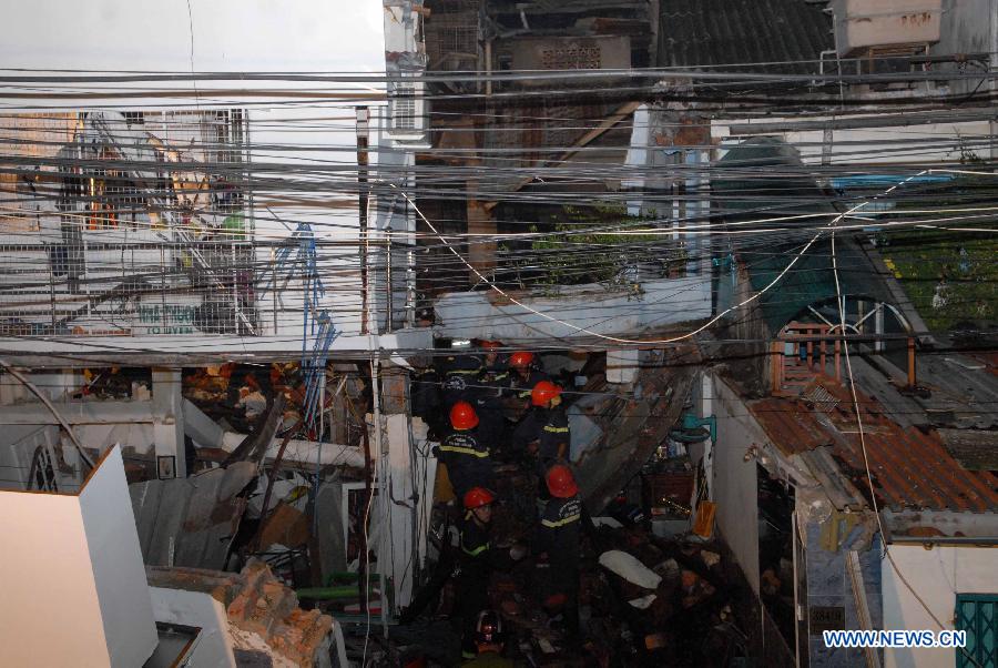 Rescuers search for survivors at a collapsed building after an explosion in Ho Chi Minh City, Vietnam, on Feb. 24, 2013. A total of seven people were confirmed dead and three went missing after three houses in a small alley in south Vietnam's Ho Chi Minh City's District 3 collapsed following two explosions at dawn on Sunday, said the police. (Xinhua/VNA)