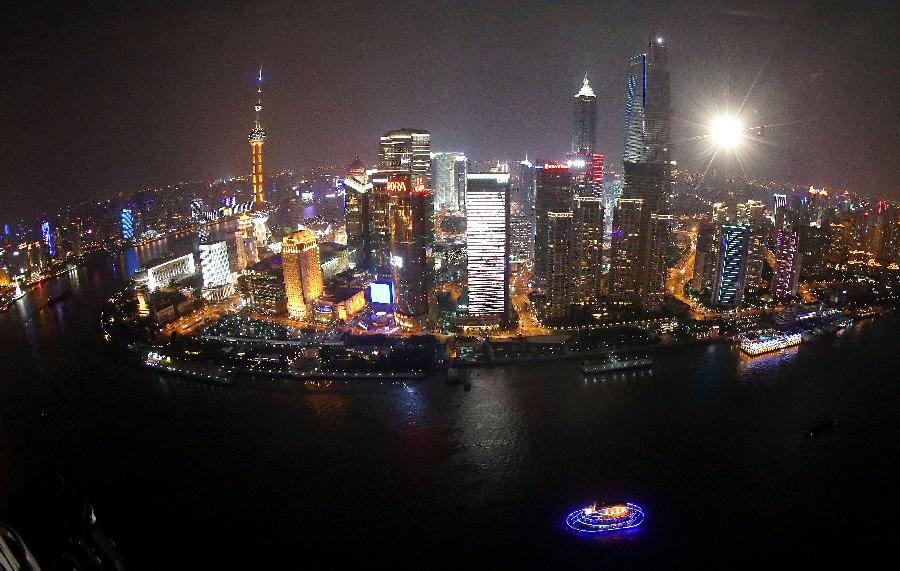 Photo taken on Feb. 24, 2013 shows the aerial view of the illuminated buildings along the banks of the Huangpu River in Shanghai, east China. (Xinhua/Fan Jun) 