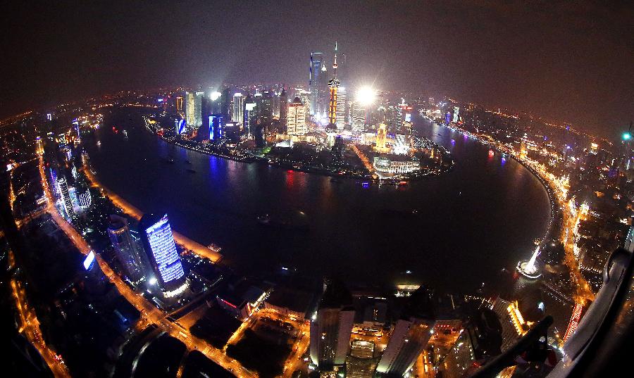 Photo taken on Feb. 24, 2013 shows the aerial view of the illuminated buildings along the banks of the Huangpu River in Shanghai, east China. (Xinhua/Fan Jun) 